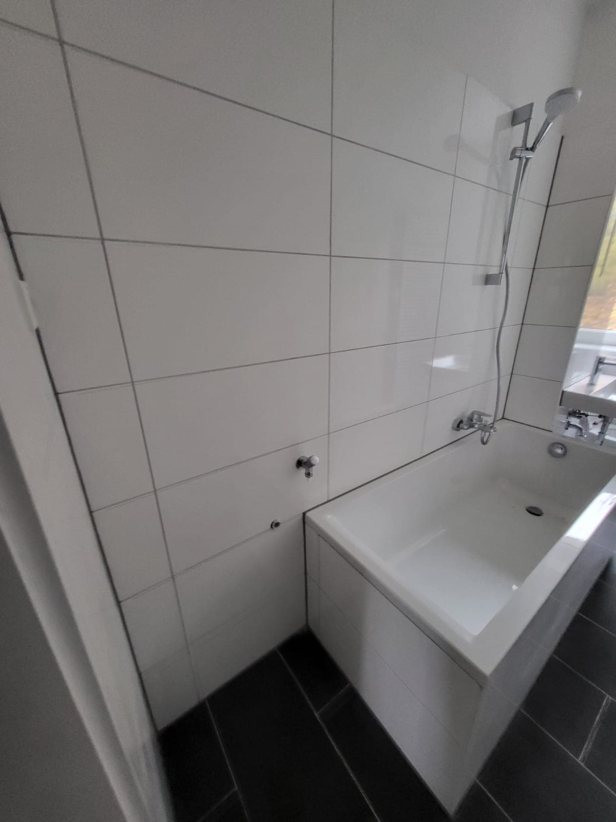 Wannenbad mit weißer Großfliese — Bäder, NRW · Deutschland · Trust NordBau